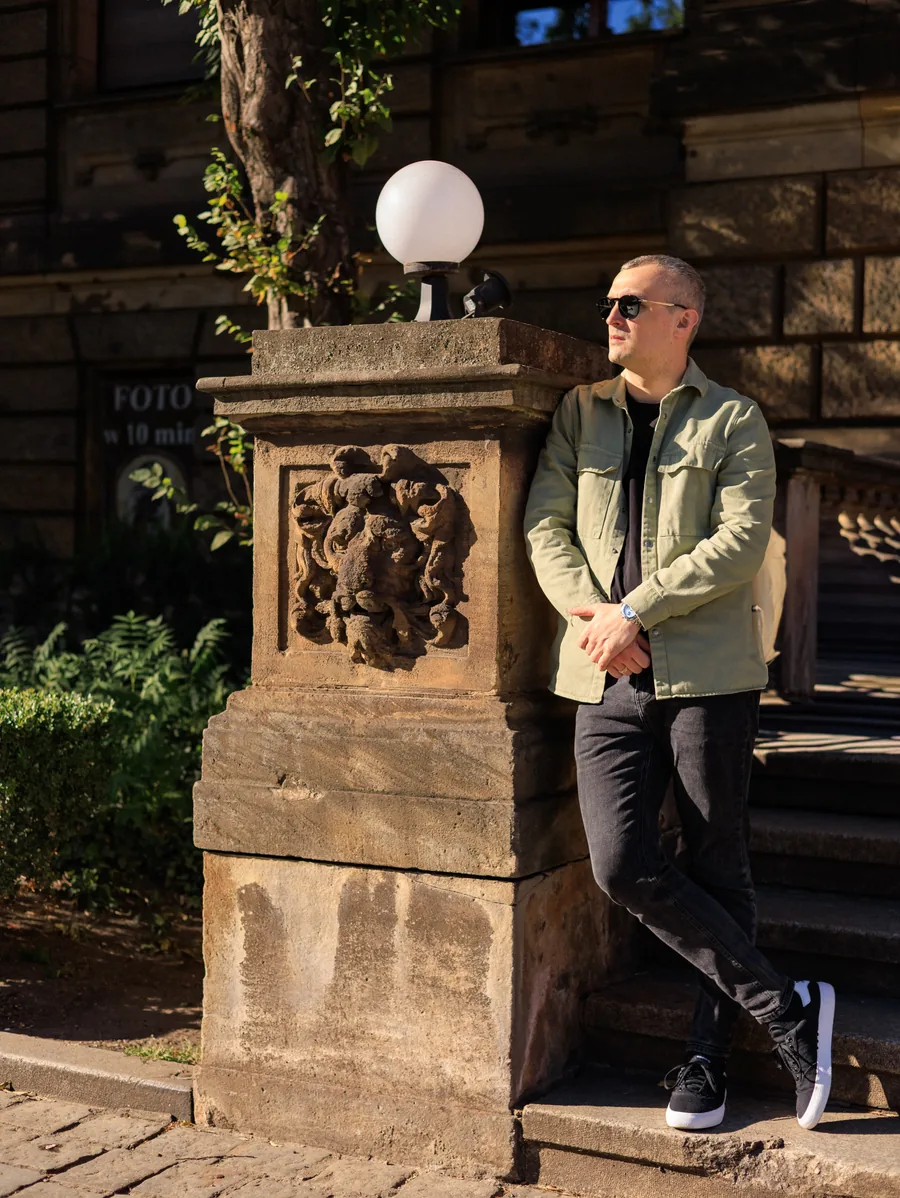 Yaroslav Volkov wearing sunglasses and standing beside a stone balustrade.